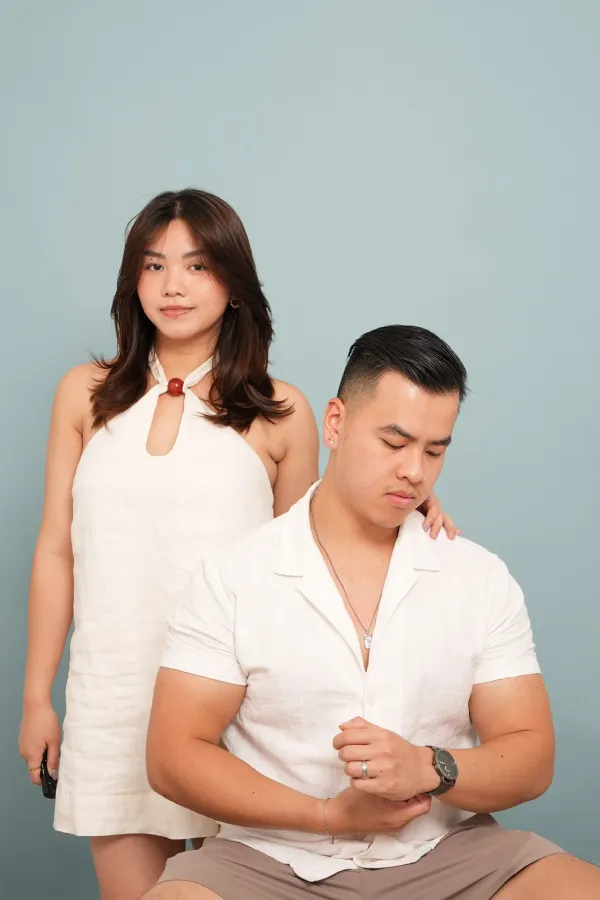 A woman standing behind a man